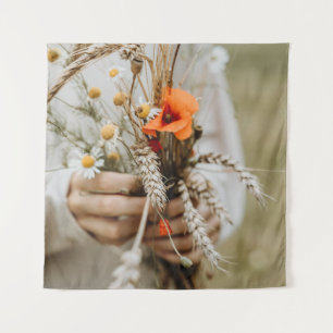 PERSON HOLDING ORANGE PEALED FLOWER TAPESTRY