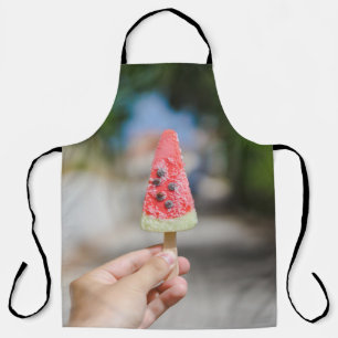 Person holding popsicle in the morning apron