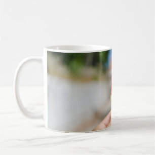Person holding popsicle in the morning coffee mug