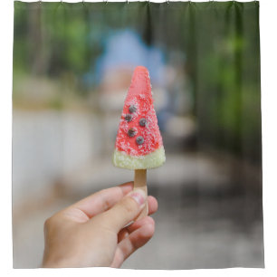 Person holding popsicle in the morning shower curtain