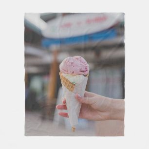 Person holding strawberry ice cream fleece blanket
