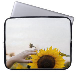 Person holding sunflower laptop sleeve