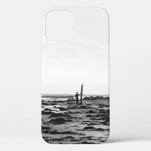 PERSON HOLDING SURFBOARD NEAR BODY OF WATER iPhone 12 CASE