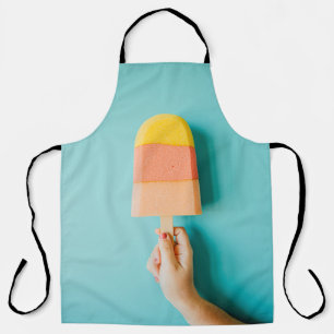 Person holding yellow and brown ice cream cone apron