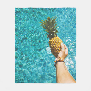 Person holding yellow pineapple fleece blanket