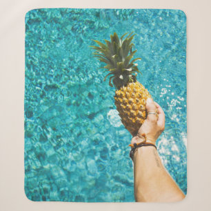 Person holding yellow pineapple sherpa blanket