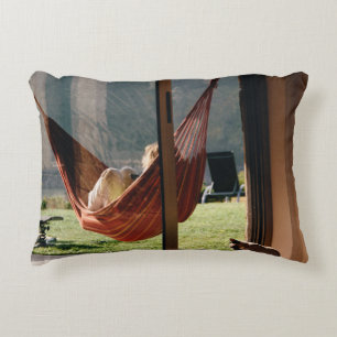 Person on brown swing decorative cushion