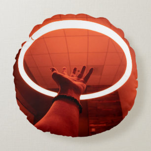 PERSON REACHING ROUND TURNED-ON FLUORESCENT LAMP I CUSHION