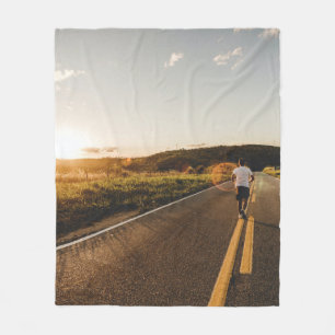 Person running in road in the morning fleece blanket