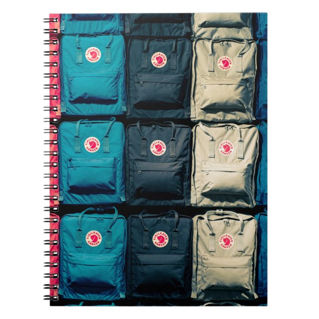 Person showing assorted-colour bags notebook (Front)