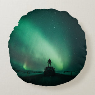 PERSON STANDING IN FRONT OF AURORA LIGHTS ROUND CUSHION