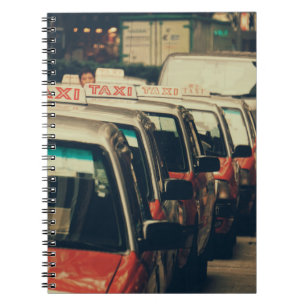 PERSON STANDING NEAR PARKED TAXI DURING DAYTIME NOTEBOOK