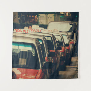 PERSON STANDING NEAR PARKED TAXI DURING DAYTIME TAPESTRY