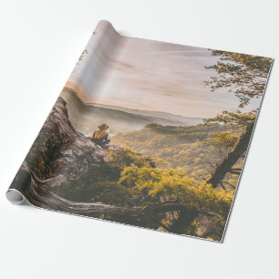 PERSON STANDING ON CLIFF NEAR TREE ON MOUNTAIN WRAPPING PAPER