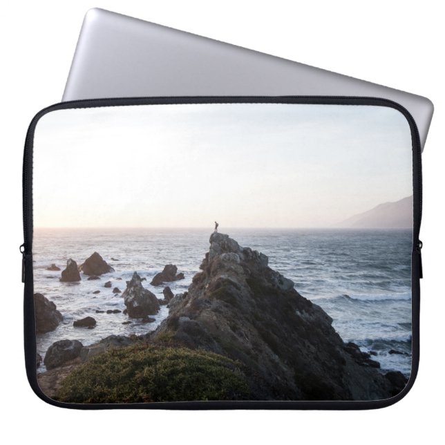 PERSON STANDING ON ROCK CLIFF NEAR BODY OF WATER LAPTOP SLEEVE (Front)