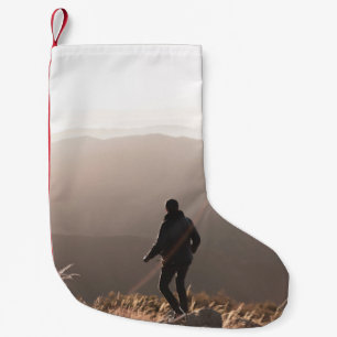 Person standing on rock small christmas stocking