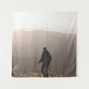 Person standing on rock tapestry