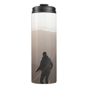 Person standing on rock thermal tumbler