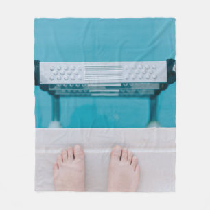 Person standing on swimming pool ladder fleece blanket