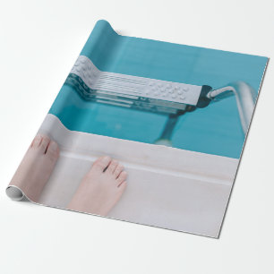 Person standing on swimming pool ladder wrapping paper