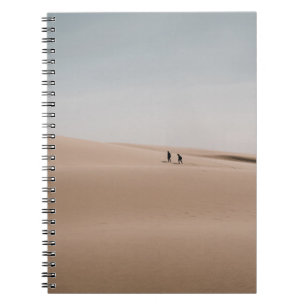 PERSON WALKING ON BROWN SAND DURING DAYTIME NOTEBOOK