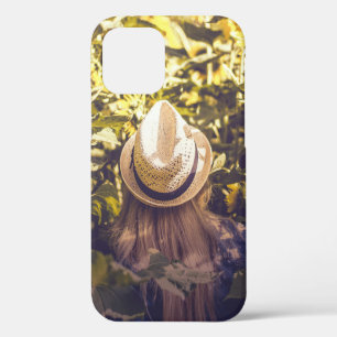 Person wearing white hat beside sunflower fields iPhone 12 case