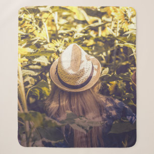 Person wearing white hat beside sunflower fields sherpa blanket