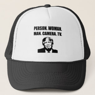 Person. Woman. Man. Camera. TV. Anti-Trump Trucker Hat