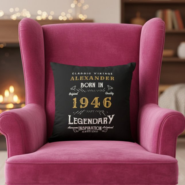 Personalised 80th Birthday Born 1946 Legend Black Cushion (Born 1946 throw pillow on a pink chair.)