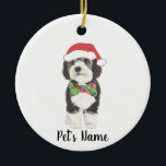 Personalised Bernedoodle Santa Hat & Bowtie Ceramic Ornament<br><div class="desc">I am in love with this beautifully detailed watercolor illustration of a grey, black, and white bernedoodle or sheepadoodle on a an ornament with a sweet little red and green bow tie and santa hat combo! Personalise these ornaments and make the nice list this year! For the perfect presents, pair...</div>