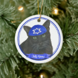 Personalised Black Cat Hanukkah Yarmulke Blue Ceramic Ornament<br><div class="desc">Celebrate your favourite mensch on a bench with personalised ornament! This design features a sweet illustration of a black cat with a blue and white yarmulke. For the most thoughtful gifts, pair it with another item from my collection! To see more work and learn about this artist, visit her at...</div>