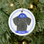 Personalised Black Great Dane Dog Hanukkah Ceramic Ornament<br><div class="desc">Celebrate your favourite mensch on a bench with personalised ornament! This design features a sweet illustration of a black great dane dog with a blue and white yarmulke. For the most thoughtful gifts, pair it with another item from my collection! To see more work and learn about this artist, visit...</div>