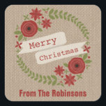 Personalised Burlap Inspired Wreath Christmas Square Sticker<br><div class="desc">A Christmas sticker featuring an illustration of a red and green floral wreath accented with holly.  Banner over wreath says,  "Merry Christmas."  Background is burlap inspired.  Personalise with your family's name at bottom.</div>