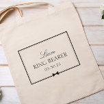 Personalised Classic Simple Bowtie Ring Bearer Tote Bag<br><div class="desc">Celebrate your ring bearer in style with this charming, customisable tote bag. Featuring an elegant black-and-white design, it showcases the ring bearer's name, title, and special date framed by a sleek border and a delicate bowtie illustration. Perfect for holding wedding day essentials, this tote adds a thoughtful touch to your...</div>