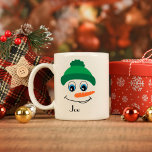 Personalised Custom Name Snowman Green Hat Coffee Mug<br><div class="desc">Sip your favourite warm beverage with a touch of holiday cheer with this personalised coffee mug! Featuring a cheerful snowman wearing a green hat and scarf, this mug brings a festive winter vibe to your morning routine. Add your name or a loved one's for that personal touch, making it a...</div>