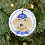 Personalised English Cream Dachshund Dog Hanukkah Ceramic Ornament<br><div class="desc">Celebrate your favourite mensch on a bench with personalised ornament! This design features a sweet illustration of a fawn, tan, or cream english long haired dachshund dog with a blue and white yarmulke. For the most thoughtful gifts, pair it with another item from my collection! To see more work and...</div>