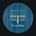 Personalised Family Name Blue Hanukkah Menorah Cutting Board<br><div class="desc">Celebrate Hanukkah with a modern twist using this deep blue design featuring a stylised menorah with glowing golden flames. The family name sits elegantly below in a refined serif font, adding a personal and festive touch. Perfect for holiday hosting, this design is ideal for families who value tradition, warmth, and...</div>