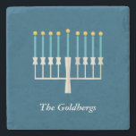 Personalised Family Name Hanukkah Menorah Blue Stone Coaster<br><div class="desc">Celebrate Hanukkah with this elegant personalised stone coaster featuring a beautifully designed menorah on a classic blue background. Perfect for adding a festive touch to your home decor, this coaster makes a thoughtful holiday gift or a stylish addition to your Hanukkah table setting. Customise with a family name for a...</div>