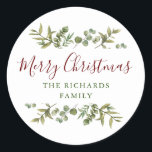 Personalised Merry Christmas Greenery Family  Classic Round Sticker<br><div class="desc">Watercolor greenery frames elegant script Merry Christmas typography on these elegant holiday stickers. Personalise with your family name. Designed by Thisisnotme©</div>