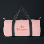 Personalised Mrs. Bride Name Pink Orange Script Duffle Bag<br><div class="desc">Travel in style with this personalised pink duffle bag featuring the bride's name in bold orange script. Perfect for the bride-to-be, this trendy and practical bag is ideal for bachelorette parties, bridal showers, or honeymoon trips. The vibrant colour combination and custom design make it a unique and thoughtful gift for...</div>