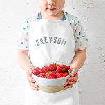 Personalised Name Monogram | Dusty Blue Kids Apron<br><div class="desc">These personalised kids' aprons feature your child's name in a modern arched font, making them perfect for young chefs helping in the kitchen, creative dress-up play, or as artist smocks to protect clothes during crafting. Made from durable, easy-to-clean fabric, these aprons add a fun, personal touch while keeping your little...</div>