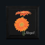 Personalised Orange Gerbera Daisies Trinket Box<br><div class="desc">This customisable black jewellery box has a pair of bright orange gerbera daisies on it,  with a spot to add your name,  initials,  or other text. If you have any requests for changes,  or need help customising this with your text,  please email niteowlstudio@gmail.com.</div>