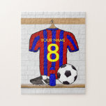 Personalised Red and Blue Football Soccer Jersey Jigsaw Puzzle<br><div class="desc">Add the name and number or age of the soccer player, football fan or soccer team coach to this unique sports design featuring a red and blue striped football soccer jersey hanging in the locker room. There is a water bottle, a soccer ball and football cleats on the bench under...</div>