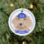 Personalised Red English Dachshund Dog Hanukkah Ceramic Ornament<br><div class="desc">Celebrate your favourite mensch on a bench with personalised ornament! This design features a sweet illustration of a red english long haired dachshund dog with a blue and white yarmulke. For the most thoughtful gifts, pair it with another item from my collection! To see more work and learn about this...</div>