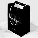 Personalised Script Groomsmen's name and Monogram  Medium Gift Bag<br><div class="desc">Add a personal touch to your wedding with personalised groomsmen gift bag. This gift bag features personalised groomsman's name in white classic script font style with wedding details in white classic serif font style and monogram in grey classic serif font style as background, on black background. Also perfect for best...</div>