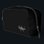 Personalised Script Monogram and Name Groomsmen Dopp Kit<br><div class="desc">Add a personal touch to your wedding with personalised groomsmen gift. This design features personalised groomsman's name in white classic script font style with wedding details in white classic serif font style and monogram in light grey classic serif font style as background on black background. Also perfect for best man,...</div>