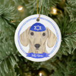 Personalised Smooth Cream Dachshund Dog Hanukkah Ceramic Ornament<br><div class="desc">Celebrate your favourite mensch on a bench with personalised ornament! This design features a sweet illustration of a smooth tan cream dachshund dog with a blue and white yarmulke. For the most thoughtful gifts, pair it with another item from my collection! To see more work and learn about this artist,...</div>