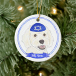 Personalised White Doodle Dog Hanukkah Ceramic Ornament<br><div class="desc">Celebrate your favourite mensch on a bench with personalised ornament! This design features a sweet illustration of a white doodle dog with a blue and white yarmulke. For the most thoughtful gifts, pair it with another item from my collection! To see more work and learn about this artist, visit her...</div>