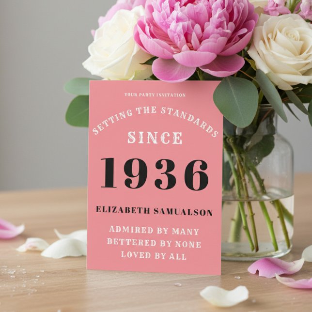 Personalized 90th Birthday 1936 Add Your Name Pink Invitation (1936 pink birthday invitation on a table with flowers)