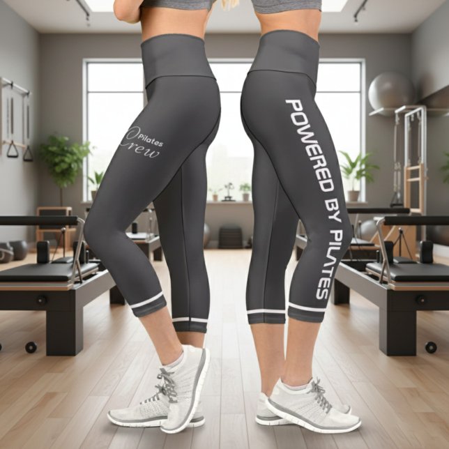 Personalized Powered By Pilates Dark Grey Capri Leggings (Powered by Pilates Grey Leggings. Gym background.)